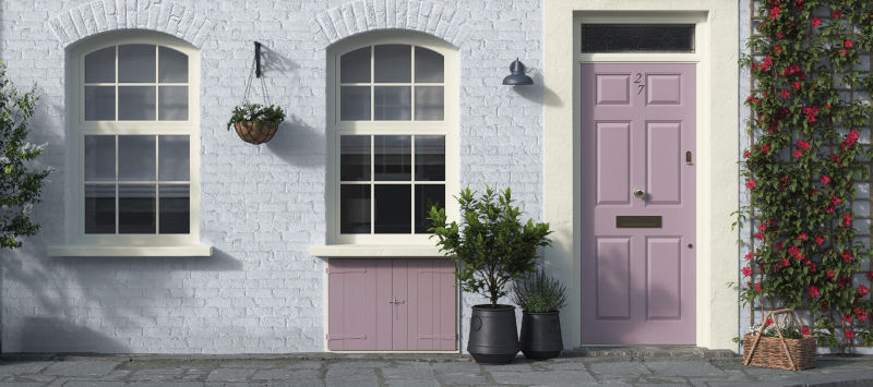 A terraced cottage with beautifully painted masonry and contrasting front door 