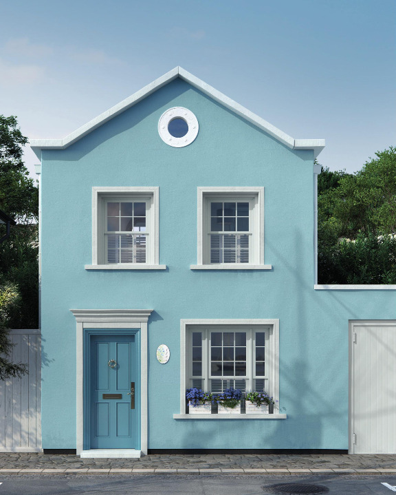 A beachside cottage painted in pales blues and whites