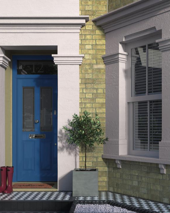 A victorian bay window and blue front door with 